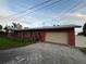 Exterior view of the home with a garage and a well-maintained yard at 9907 Maggie St, Gibsonton, FL 33534