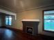 Living room featuring a classic fireplace with a dark brick surround and mantel at 9907 Maggie St, Gibsonton, FL 33534