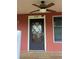 A close-up of the front door with a decorative window and the house number above at 9907 Maggie St, Gibsonton, FL 33534