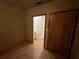 Hallway view with doors leading to a bathroom, featuring tile floors at 9907 Maggie St, Gibsonton, FL 33534