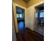 Hallway with wooden floors connecting bedroom and bathroom at 9907 Maggie St, Gibsonton, FL 33534