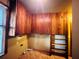 This kitchen features wood cabinets and shelving and tile flooring at 9907 Maggie St, Gibsonton, FL 33534