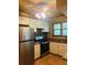 Updated kitchen features stainless steel appliances, stone backsplash, and tile flooring at 9907 Maggie St, Gibsonton, FL 33534