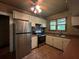 Updated kitchen features stainless steel appliances and decorative stone backsplash at 9907 Maggie St, Gibsonton, FL 33534