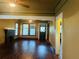 Open living room showcasing hardwood floors, a fireplace, and ample natural light from large windows at 9907 Maggie St, Gibsonton, FL 33534