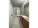 Full bathroom with a single sink vanity, tile floors and tub shower at 10823 Brickside Ct, Riverview, FL 33579