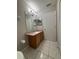 Bright bathroom includes a large mirror, granite countertop and tile flooring at 10823 Brickside Ct, Riverview, FL 33579