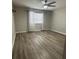 Bedroom featuring wood-look flooring, neutral paint, and a ceiling fan at 10823 Brickside Ct, Riverview, FL 33579
