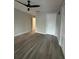 This bedroom features wood-look flooring with entry to another room at 10823 Brickside Ct, Riverview, FL 33579