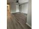 This bedroom features wood-look flooring and a closet with white doors at 10823 Brickside Ct, Riverview, FL 33579