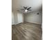A spacious bedroom featuring wood-look floors, and large closets at 10823 Brickside Ct, Riverview, FL 33579