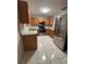 Stylish kitchen featuring stainless steel appliances, light countertops and wooden cabinets at 10823 Brickside Ct, Riverview, FL 33579