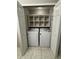 Convenient laundry closet equipped with washer, dryer, and shelving at 10823 Brickside Ct, Riverview, FL 33579