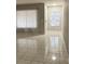 Well-lit living room boasting tile flooring, windows, and neutral paint at 10823 Brickside Ct, Riverview, FL 33579