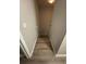 Narrow stairway leading to a lower level with durable laminate flooring at 10823 Brickside Ct, Riverview, FL 33579