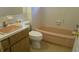 A bathroom with a vanity sink, toilet, and bathtub showcasing classic fixtures and design at 10871 86Th Ave, Seminole, FL 33772
