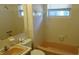 Cozy bathroom featuring tiled walls, vanity sink, bathtub, toilet, and window for natural light at 10871 86Th Ave, Seminole, FL 33772