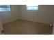 Empty bedroom with neutral carpet, two windows for natural light, and essential outlets at 10871 86Th Ave, Seminole, FL 33772