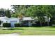 A well-landscaped single-story home with an attached garage and cozy curb appeal at 10871 86Th Ave, Seminole, FL 33772