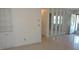Spacious living area featuring built-in shelving, terrazzo floors, and a view of the front entrance at 10871 86Th Ave, Seminole, FL 33772