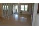 Bright living room with terrazzo floors and ample natural light, featuring mirrored wall decor at 10871 86Th Ave, Seminole, FL 33772