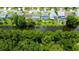 Aerial view of homes with private pools overlooking a tranquil waterway, set amongst lush greenery and manicured lawns at 11121 Clayridge Dr, Tampa, FL 33635