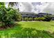 Wide backyard view highlighting the screened enclosure and mature landscaping, creating a private and appealing outdoor space at 11121 Clayridge Dr, Tampa, FL 33635