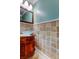 Elegant powder room with a stylish vessel sink, travertine tile and modern fixtures at 11121 Clayridge Dr, Tampa, FL 33635
