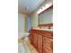 Bathroom featuring a wood vanity, neutral color scheme, tiled floor, and a shower-tub combination with blue curtains at 11121 Clayridge Dr, Tampa, FL 33635