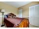 Comfortable bedroom with a wooden bed frame, neutral walls, and a spacious closet at 11121 Clayridge Dr, Tampa, FL 33635