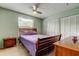 Well-lit bedroom with a wood bed frame, plush bedding, a large window, and closet space at 11121 Clayridge Dr, Tampa, FL 33635