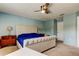 Comfortable bedroom featuring a tufted headboard, ceiling fan, and light blue walls, creating a serene atmosphere at 11121 Clayridge Dr, Tampa, FL 33635