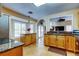 Bright kitchen featuring tile floors, granite counters, wood cabinets and access to the living room and backyard at 11121 Clayridge Dr, Tampa, FL 33635