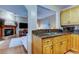 Open kitchen with maple cabinetry, granite counters, stainless steel appliances, and view to living room with fireplace at 11121 Clayridge Dr, Tampa, FL 33635