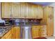 Kitchen features maple cabinetry, granite counters, tile backsplash and stainless steel appliances at 11121 Clayridge Dr, Tampa, FL 33635