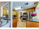 Kitchen with stainless steel appliances, granite countertops, maple cabinetry, and access to living room at 11121 Clayridge Dr, Tampa, FL 33635
