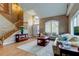 Bright living room featuring a staircase, and an arched doorway with abundant natural light at 11121 Clayridge Dr, Tampa, FL 33635