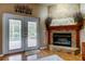 Living room with stone fireplace, mantle and view to backyard with pool at 11121 Clayridge Dr, Tampa, FL 33635