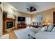 Bright living room with fireplace, ceiling fan, wood floors and view to kitchen at 11121 Clayridge Dr, Tampa, FL 33635