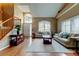 Open-concept living room with hardwood floors, plantation shutters, and staircase at 11121 Clayridge Dr, Tampa, FL 33635