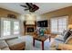 Inviting living room featuring a fireplace, ceiling fan, and comfortable seating area at 11121 Clayridge Dr, Tampa, FL 33635