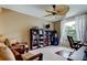 Cozy office space with a ceiling fan, large window, and built-in bookshelf at 11121 Clayridge Dr, Tampa, FL 33635