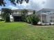 Well-manicured lawn and landscaping complement this home's lovely backyard with screened-in lanai and pool at 1178 Fraser Pine Blvd, Sarasota, FL 34240