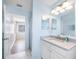 Bathroom with marble countertops, bright blue walls, and large mirror at 1178 Fraser Pine Blvd, Sarasota, FL 34240