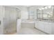 Well-lit bathroom featuring a glass enclosed shower, soaking tub, and vanity with a granite counter at 1178 Fraser Pine Blvd, Sarasota, FL 34240