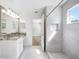 Bright bathroom featuring a marble shower, granite countertops, and modern lighting fixtures at 1178 Fraser Pine Blvd, Sarasota, FL 34240