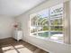 Bedroom view showcasing large windows overlooking a screened pool area at 1178 Fraser Pine Blvd, Sarasota, FL 34240
