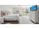 Cozy bedroom with a large bed, dresser, and a view of the outdoors through a large window at 1178 Fraser Pine Blvd, Sarasota, FL 34240