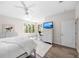 Bright bedroom with large windows, hardwood floors, and a comfortable queen-sized bed at 1178 Fraser Pine Blvd, Sarasota, FL 34240