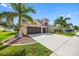 Beautiful two-story home showcasing a well-maintained lawn, palm trees, and a three-car garage at 1178 Fraser Pine Blvd, Sarasota, FL 34240